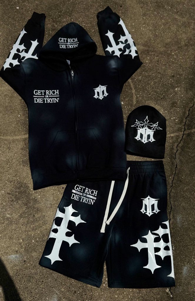 Black hoodie, shorts, and beanie set with white text and designs on a textured surface